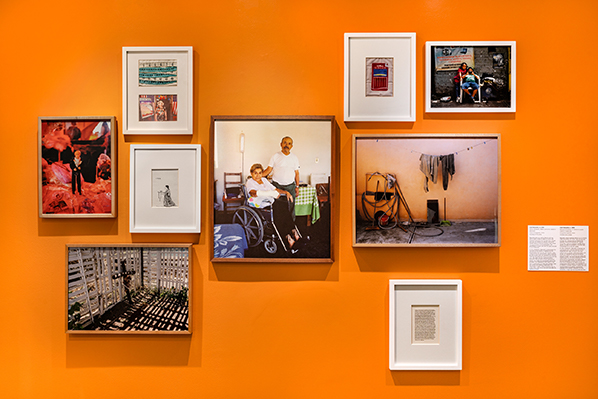 Wall of photos displayed in Otros Lados, a First Year Experience exhibition